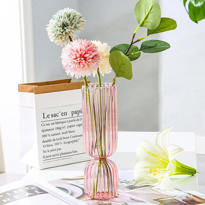 Blue glass sphere vase as a bold color accent on a minimalist white shelf