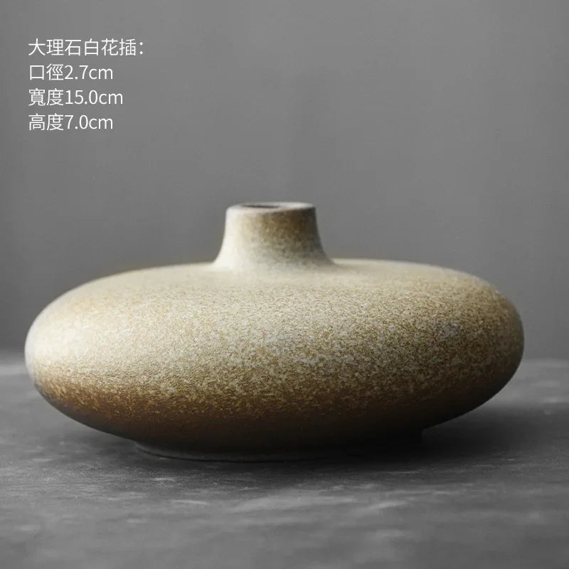 Set of abstract terracotta vases displayed on floating wall shelf
