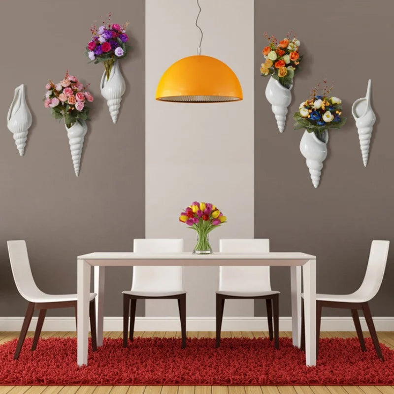 Three orientation styles of white ceramic conch wall vase displayed together