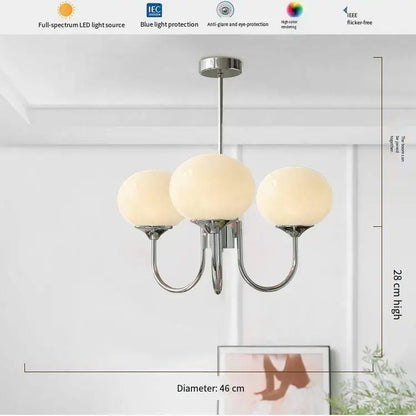 Matching frosted glass wall lamp in cream with a polished metal arm