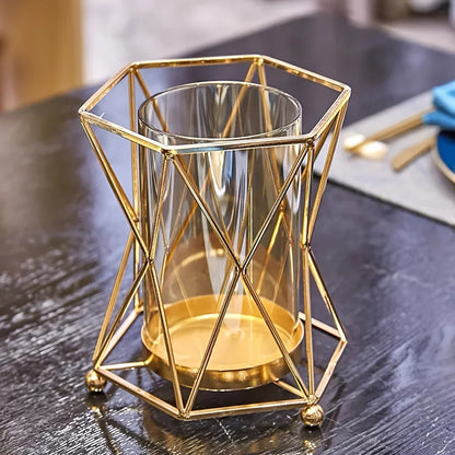 Flat lay of gold wrought iron geometric vase showing frame and glass vessel components