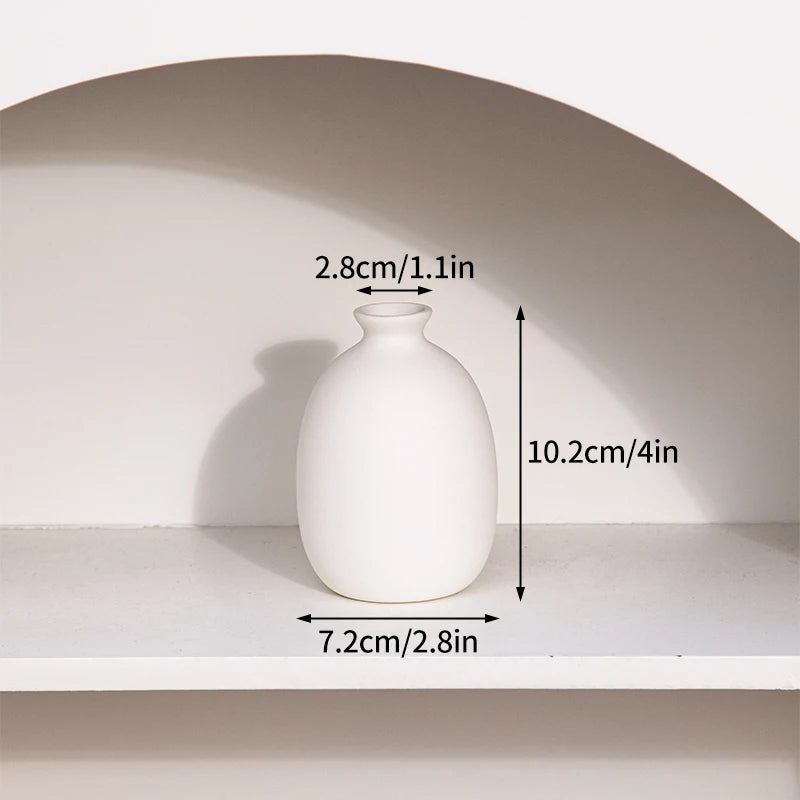 Ceramic flower bottle vases grouped on minimalist table