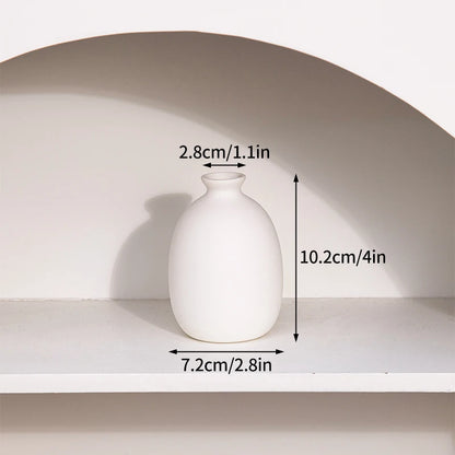 Ceramic flower bottle vases grouped on minimalist table