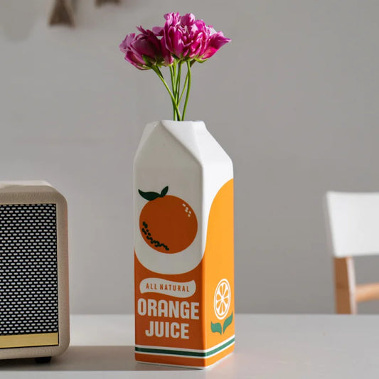 Ceramic orange fruit shaped vase on wooden dining table display