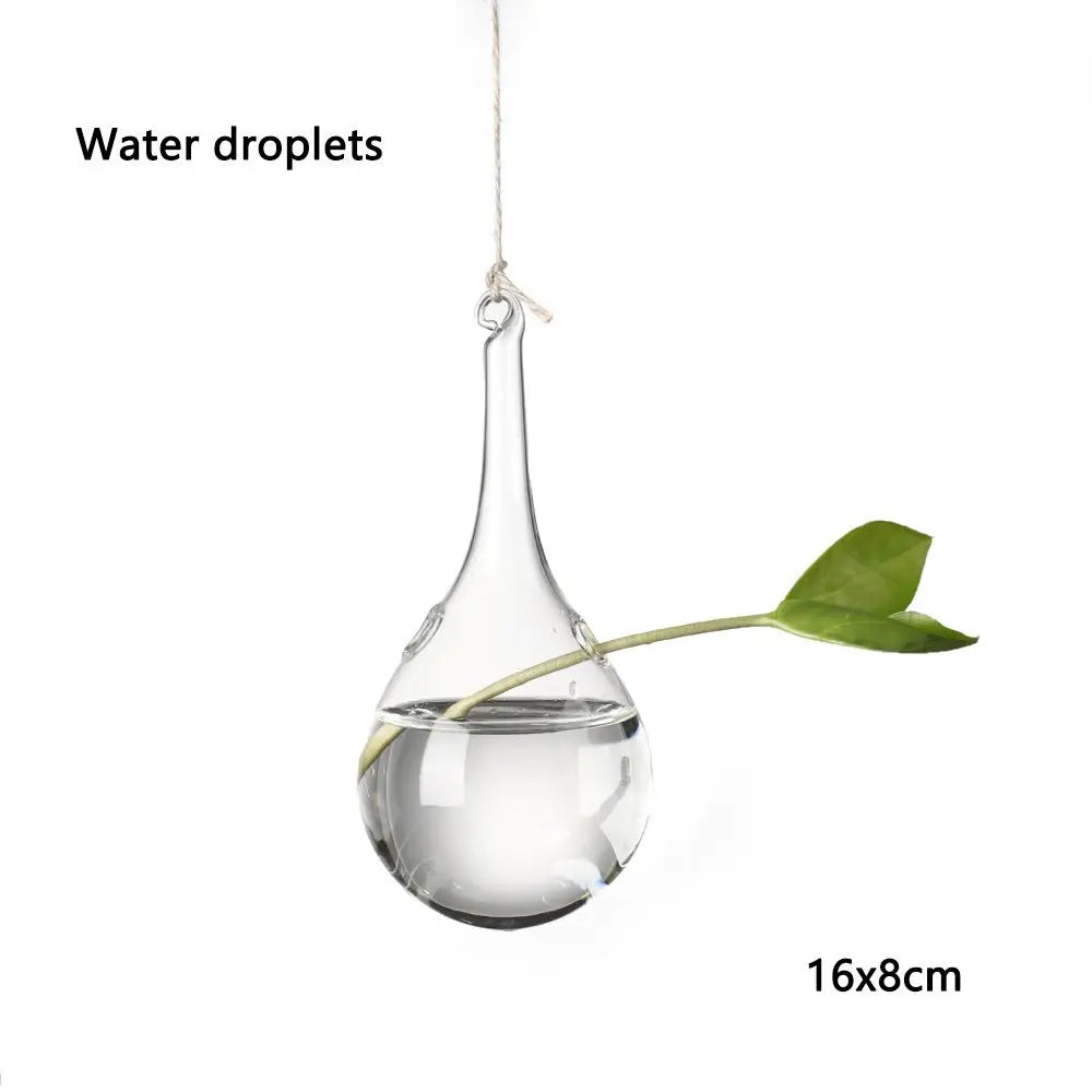 Ceiling cluster of five hanging glass ball vases in mixed shapes together