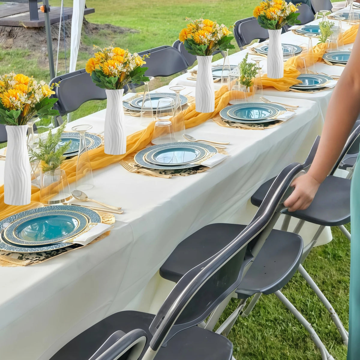 Small plastic flower vases arranged at wedding reception table