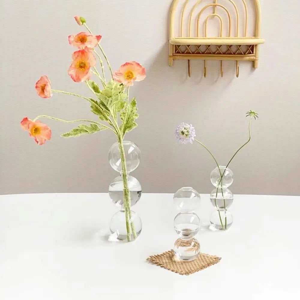Blue-L glass romantic vase as centrepiece holding fresh white flower stems on dining table