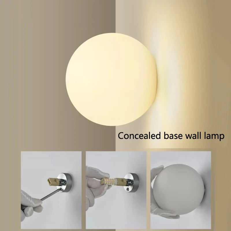 glass bathroom wall sconce, installed in a room interior setting