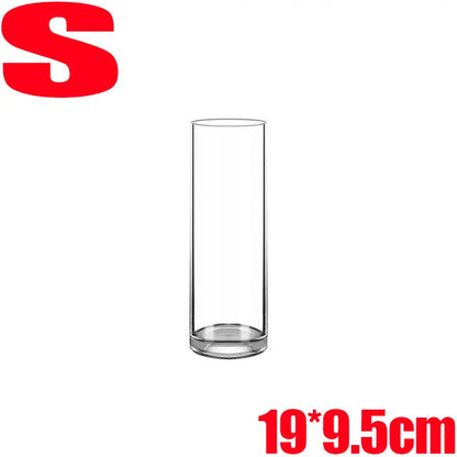 Clear acrylic cylinder vase styled in minimalist office
