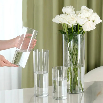 10x25cm clear plastic vase with white lily bouquet photographed from above