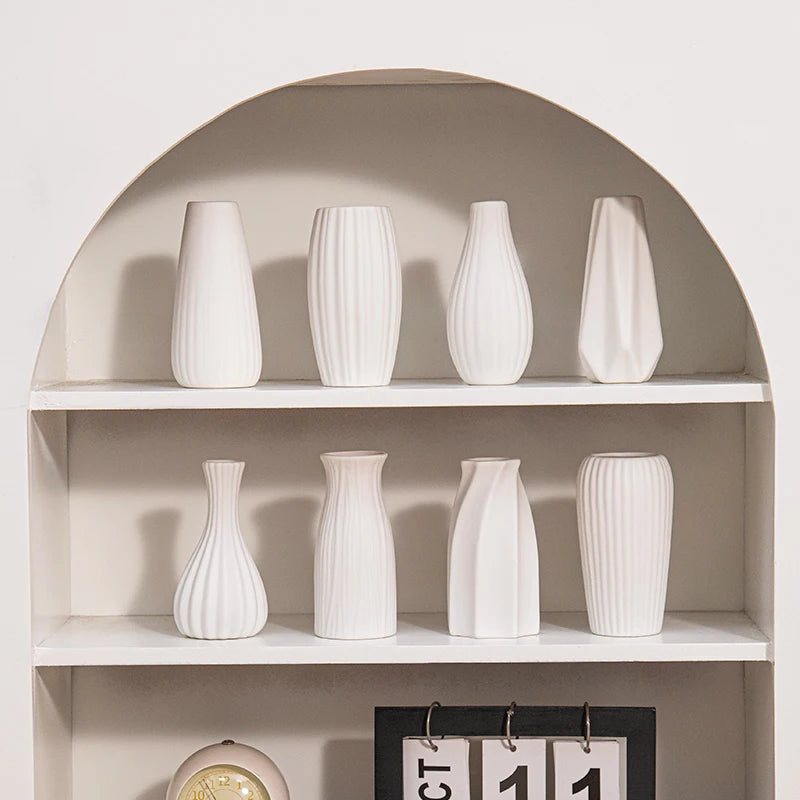 Three white Nordic ceramic vases in styles C5 C10 and D6 arranged as decorative set