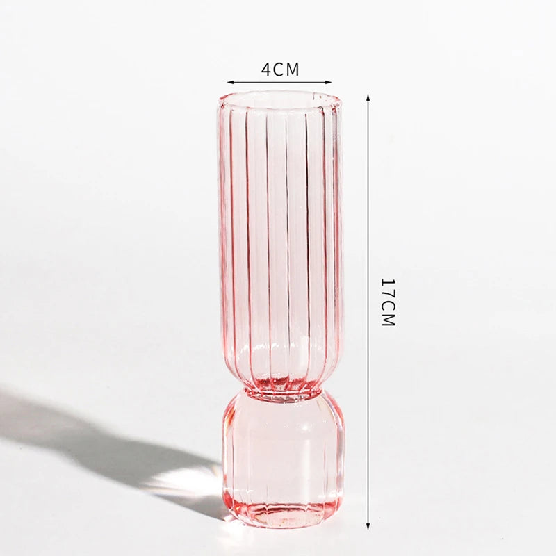 Orange and pink glass sphere vases paired together on kitchen countertop display