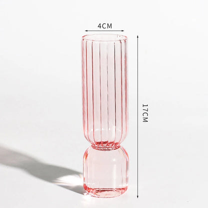 Orange and pink glass sphere vases paired together on kitchen countertop display