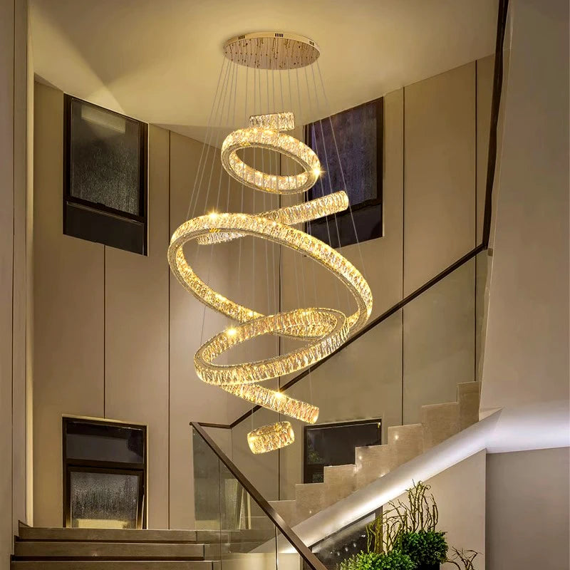 Gold ring crystal chandelier lit in warm white down a stairwell
