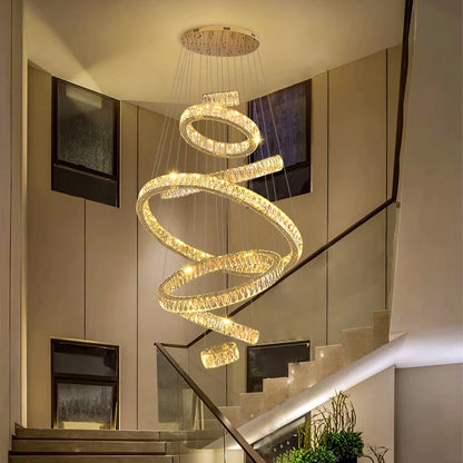 Gold ring crystal chandelier lit in warm white down a stairwell