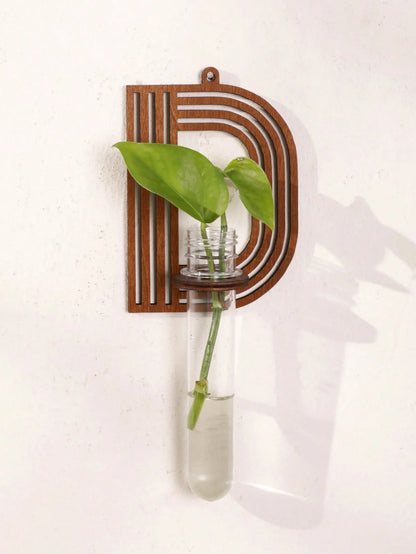 Alphabet propagation station wooden frame leaning on white wall with plants