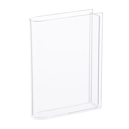 Overhead view of clear acrylic book vase showing open-book silhouette and flower display