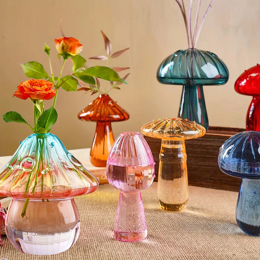 Collection of multi-colored glass mushroom vases for shelf or windowsill display