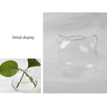 Cat-shaped glass hydroponic vase holding a small cutting in water