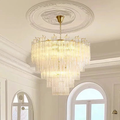 Stacked stained glass tiers casting light upward and down from a gold frame