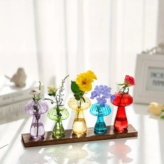 Glass mushroom-shaped hydroponic planter with translucent body and small indoor plant