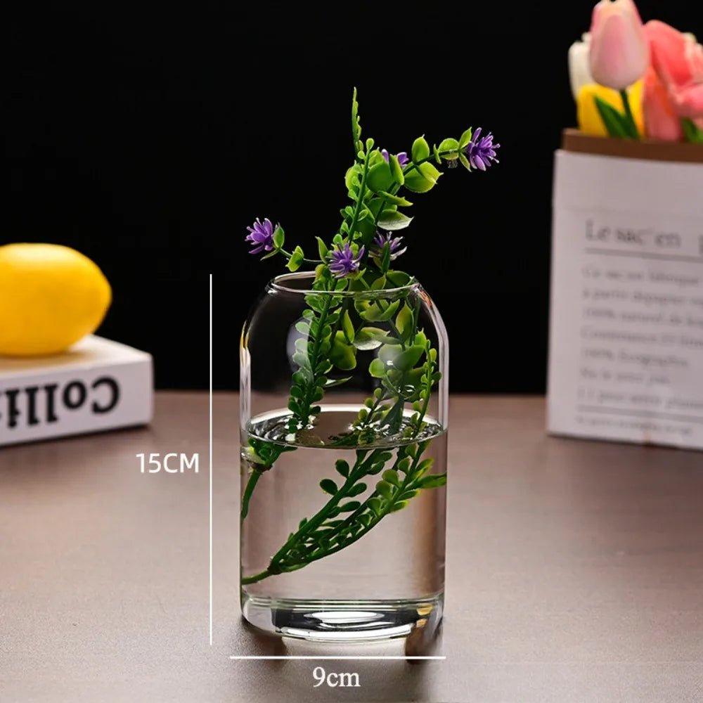 Large glass hydroponic vase with sunflower stem in Nordic interior setting