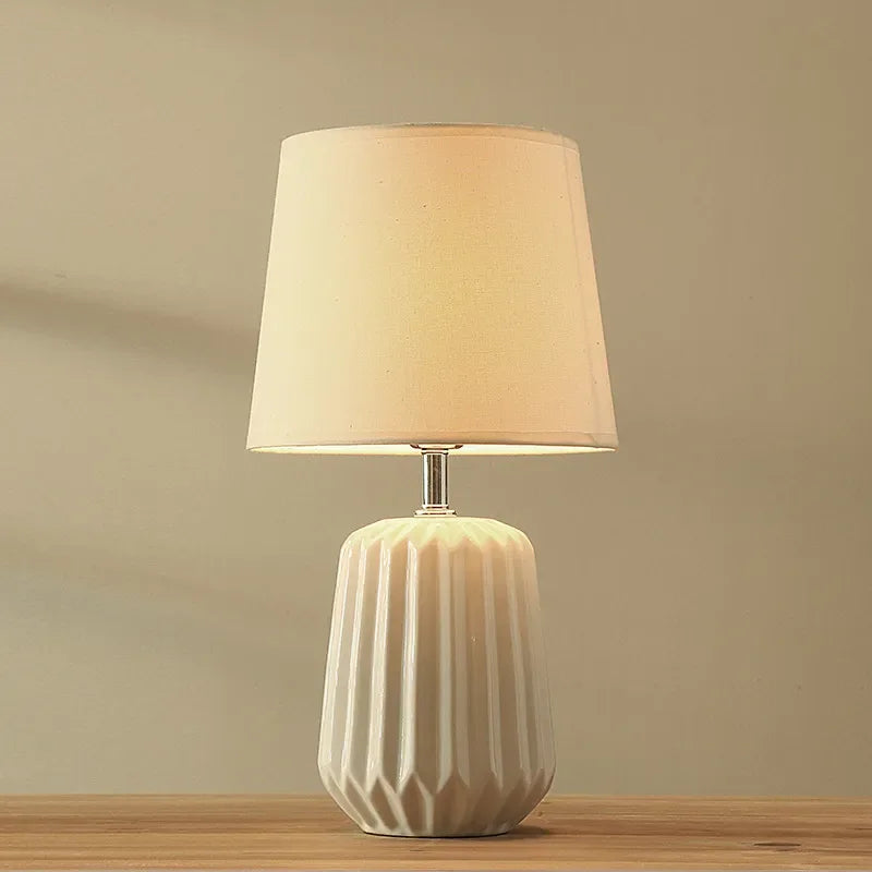 Green cloth-shade ceramic lamp in 24x45cm size on side table