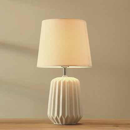 Green cloth-shade ceramic lamp in 24x45cm size on side table