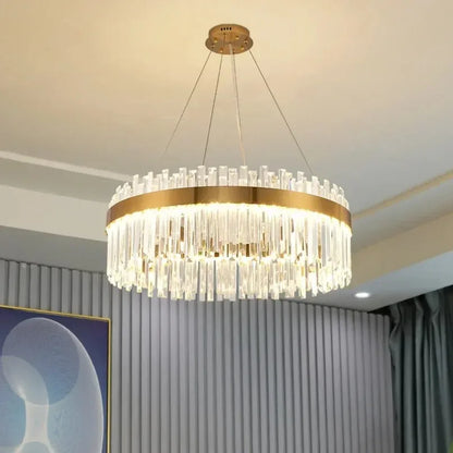 Circle crystal chandelier lit in warm white above a dining table