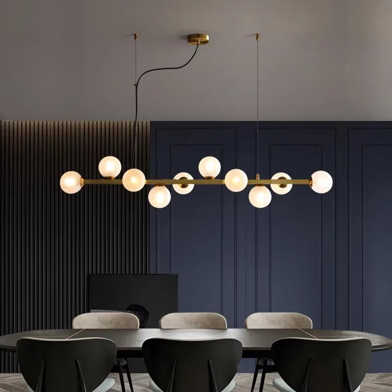 Smoky glass linear chandelier with staggered shades on a slim iron bar