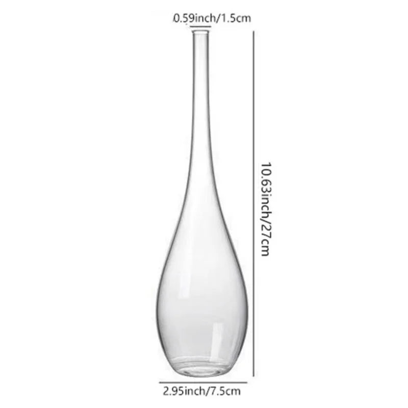 Glass cylinder bud vase reflecting natural light from a bedroom window