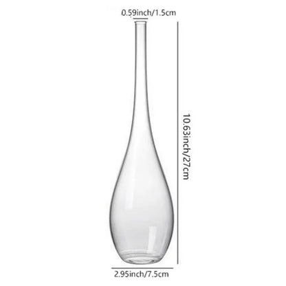 Glass cylinder bud vase reflecting natural light from a bedroom window