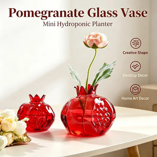 Large and small pomegranate-shaped glass vases displayed as a set on wooden shelf