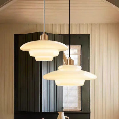 Hot bent milk glass chandelier shade on a slim cord pendant