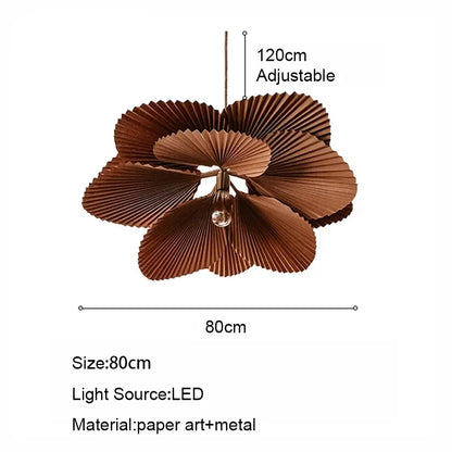 Paper fan chandelier with warm light diffusing through the shade