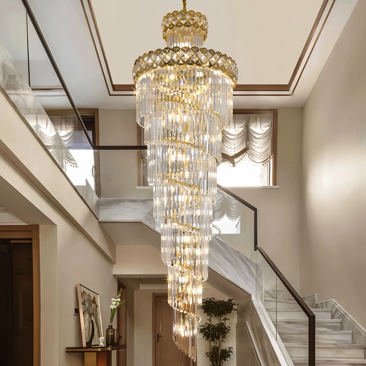 Rotating crystal staircase chandelier spiralling down a plated gold chain