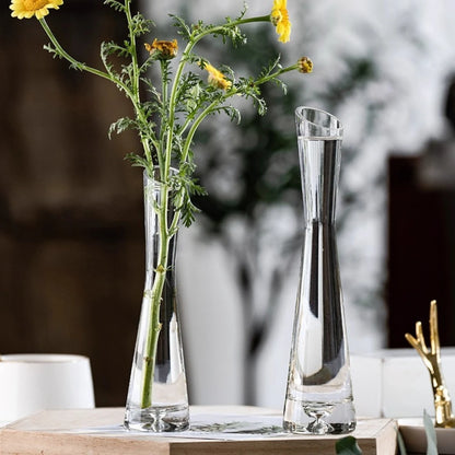 Tall slanted glass flower vase with pampas grass in modern room display