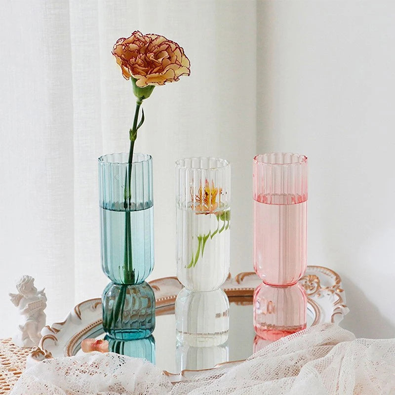 Pink glass sphere vase as a delicate accent on a modern minimalist bedside table