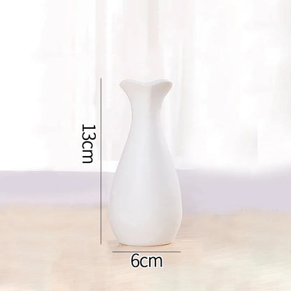 Overhead view of three Nordic white ceramic vases showing varying circular opening sizes