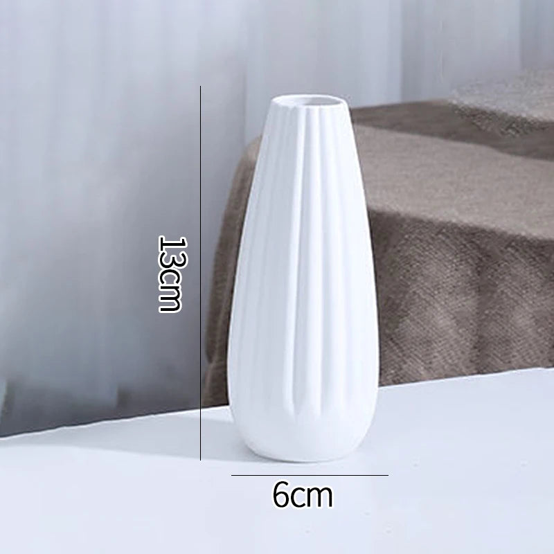 White ceramic vase C5 flat lay on grey linen textile with decorative dried seed pods