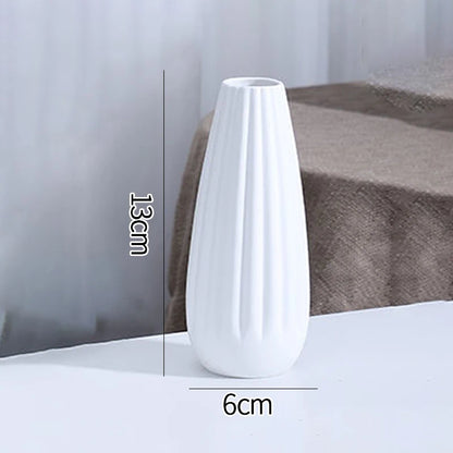 White ceramic vase C5 flat lay on grey linen textile with decorative dried seed pods