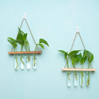 Wooden board and glass test tube wall vase styled in a botanical home office corner