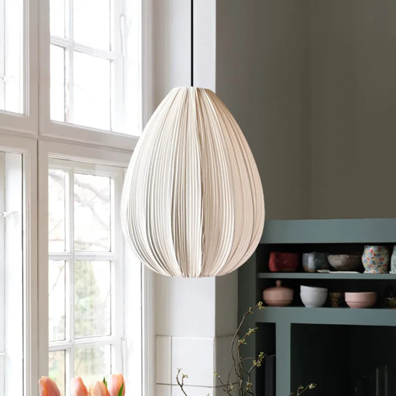 Pumpkin form fabric chandelier glowing warmly along every fold