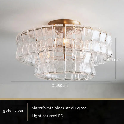 Smoke grey glass chandelier over a kitchen island in warm light