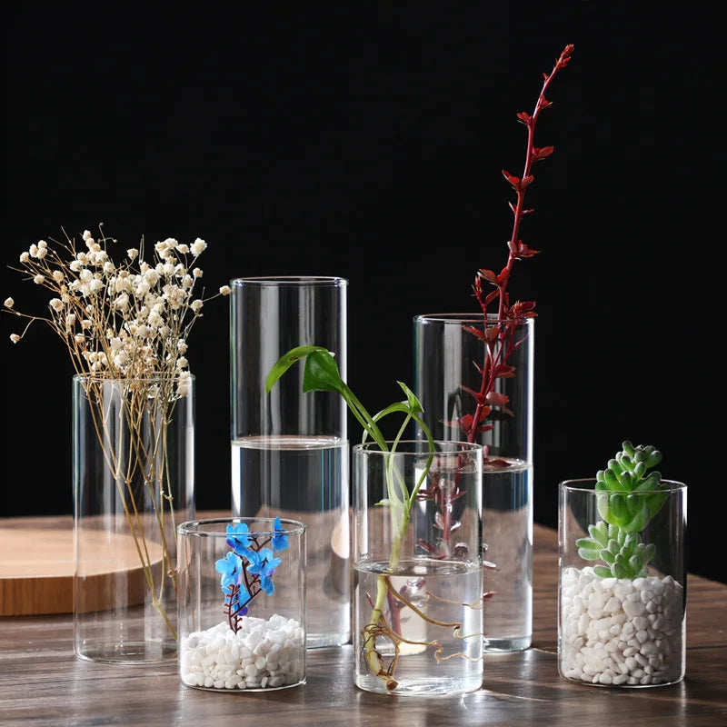 Transparent glass cylinder vase with candle inside modern home