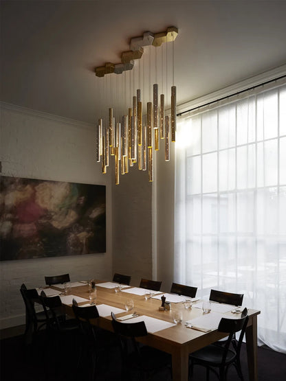 Modern hollowed chandelier of plated tubes, assembly required on installation
