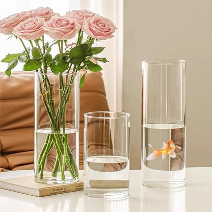 Tall clear acrylic cylinder vase with white roses as wedding centerpiece