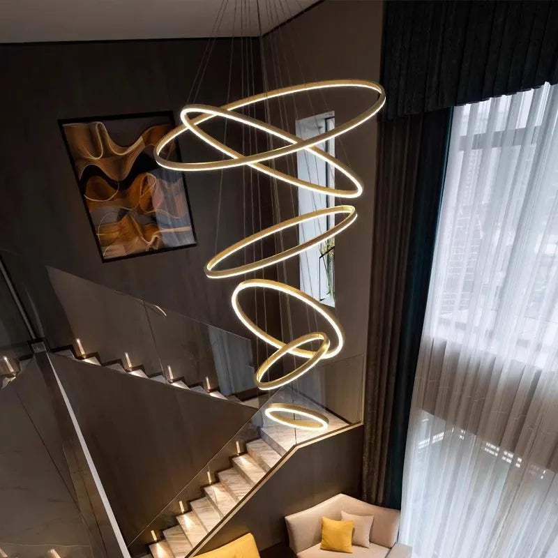 Cord pendant ring chandelier shown in warm white light for a tall living room