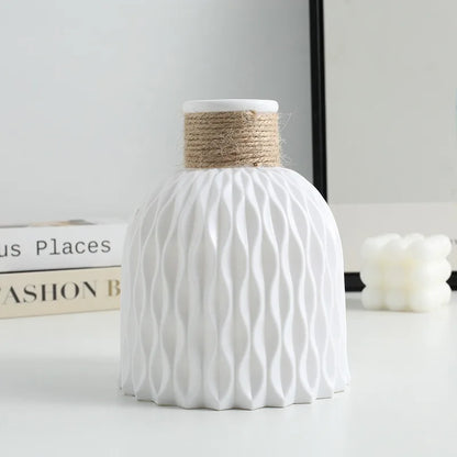 Four pineapple twine plastic vases in pink, beige, white, and grey colorways