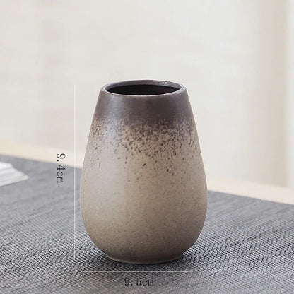 Classic Chinese pottery style I vase styled next to a calligraphy brush